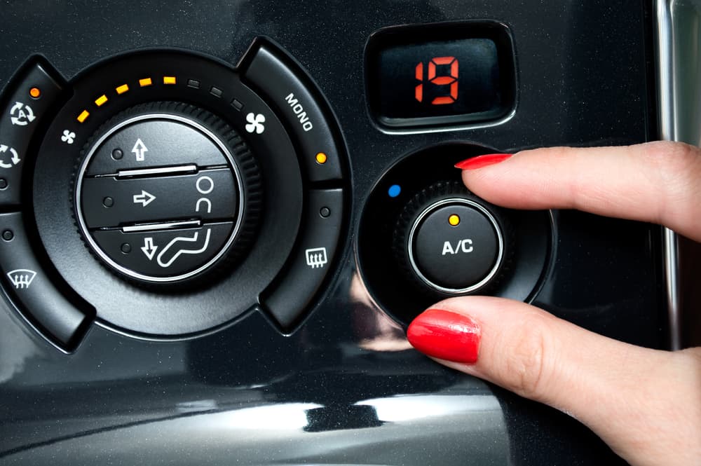 Woman Turns On Air Condition  In A Car - Auto Air Conditioning In Aitkenvale, QLD
