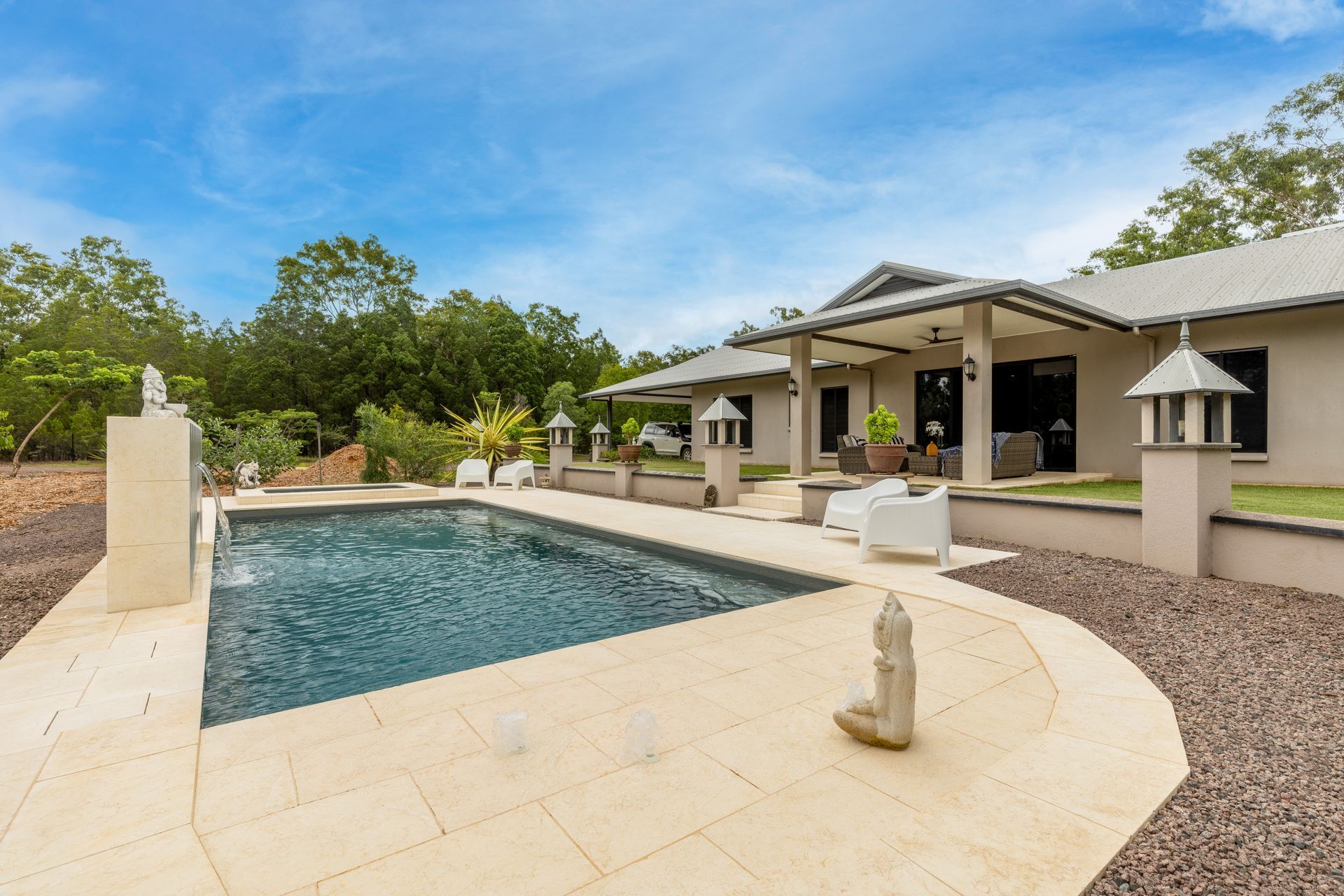 A Large House with A Large Swimming Pool in Front of It — Pooltech NT In Alawa, NT