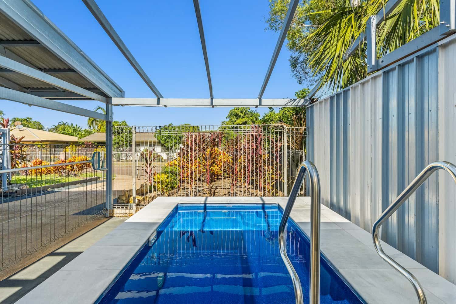 A Small Swimming Pool is Surrounded by a Fence and a Canopy — Pooltech NT In Alawa, NT