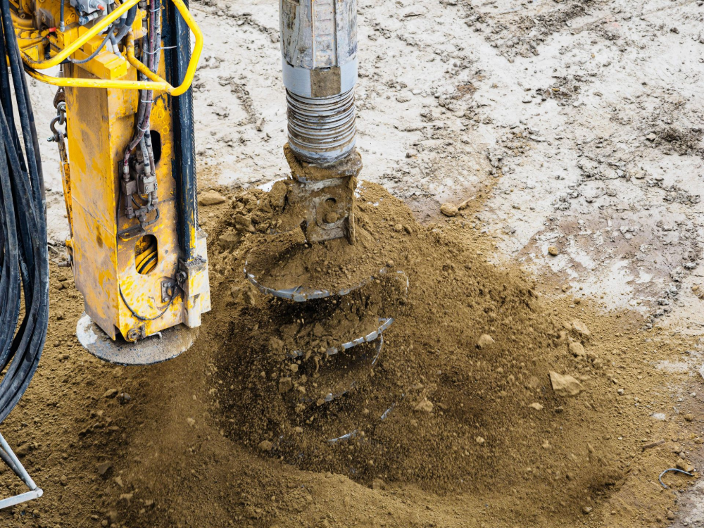 Yellow Excavator Digging Into a Brown Earth Embankment — BC Earthmoving & Civil Construction in East Barron QLD
