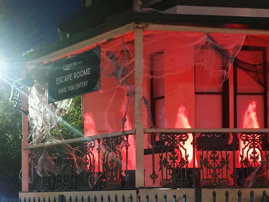 Escape This Northbridge is decorated for halloween with red lights and spider webs.