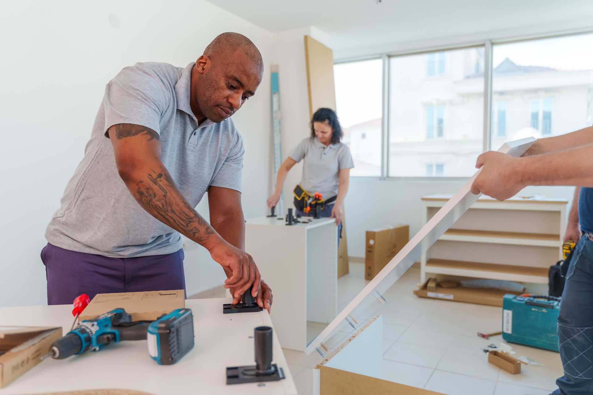 Kitchen fitters installing cabinets. Kitchen fitters installing cabinets.