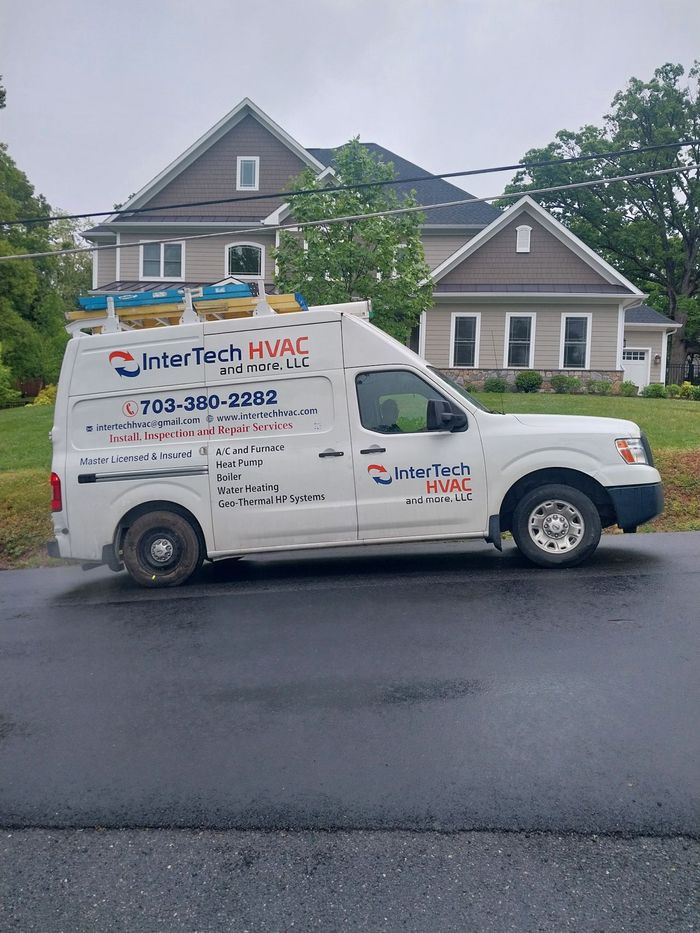 A white van is parked in front of a house.