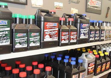 Rows of motor oil bottles on store shelves with assorted colored caps and labels | Sunshine Service Automotive Specialists