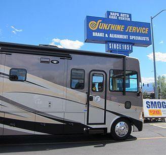 RV parked outside Sunshine Service auto shop under a blue sky | Sunshine Service Automotive Specialists