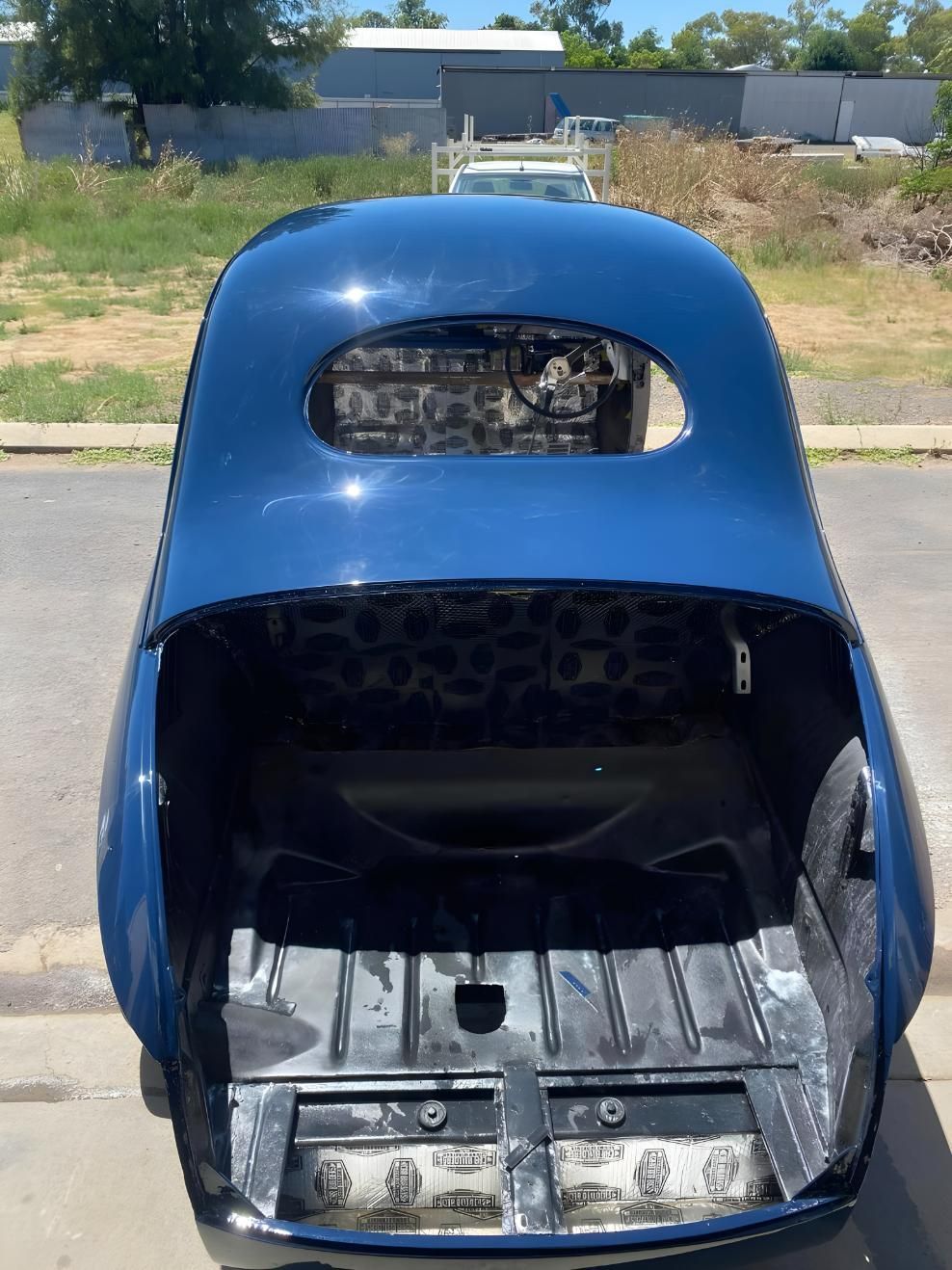 A Blue Car With the Trunk Open is Parked on the Side of the Road — M & D Shipp Smash Repairs In Dubbo, NSW