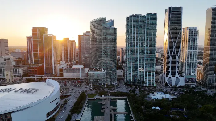 Aerial view of downtown Miami glowing at sunset before a sunset cruise Miami.
