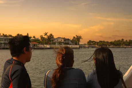 Passengers enjoying a Miami sunset boat ride while sightseeing past Star Island during a sunset cruise in Miami.