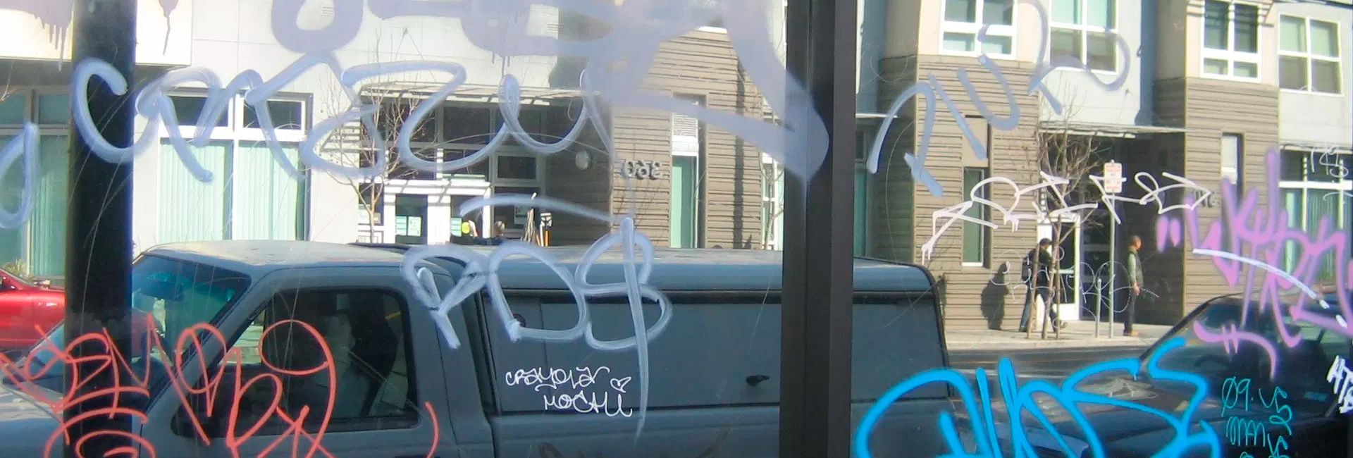 A van is parked in front of a building with graffiti on it