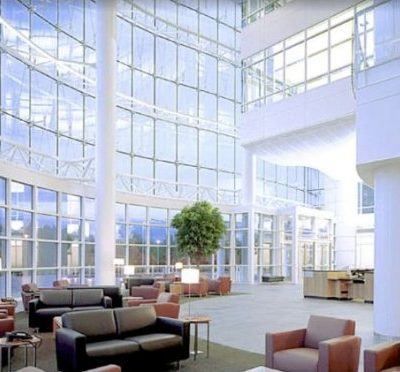 A large room with a lot of windows and furniture