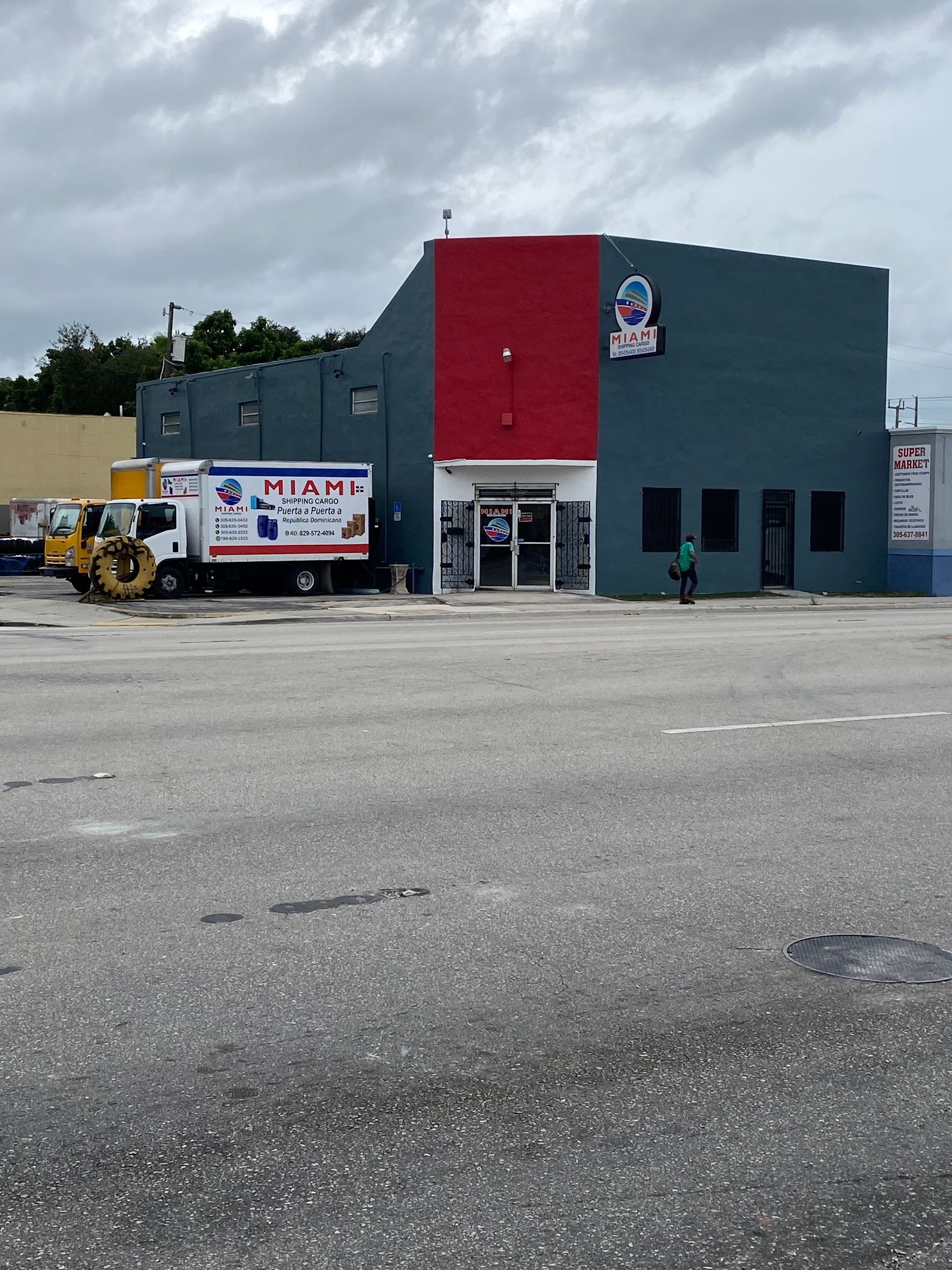 A Miami truck is parked in front of a building