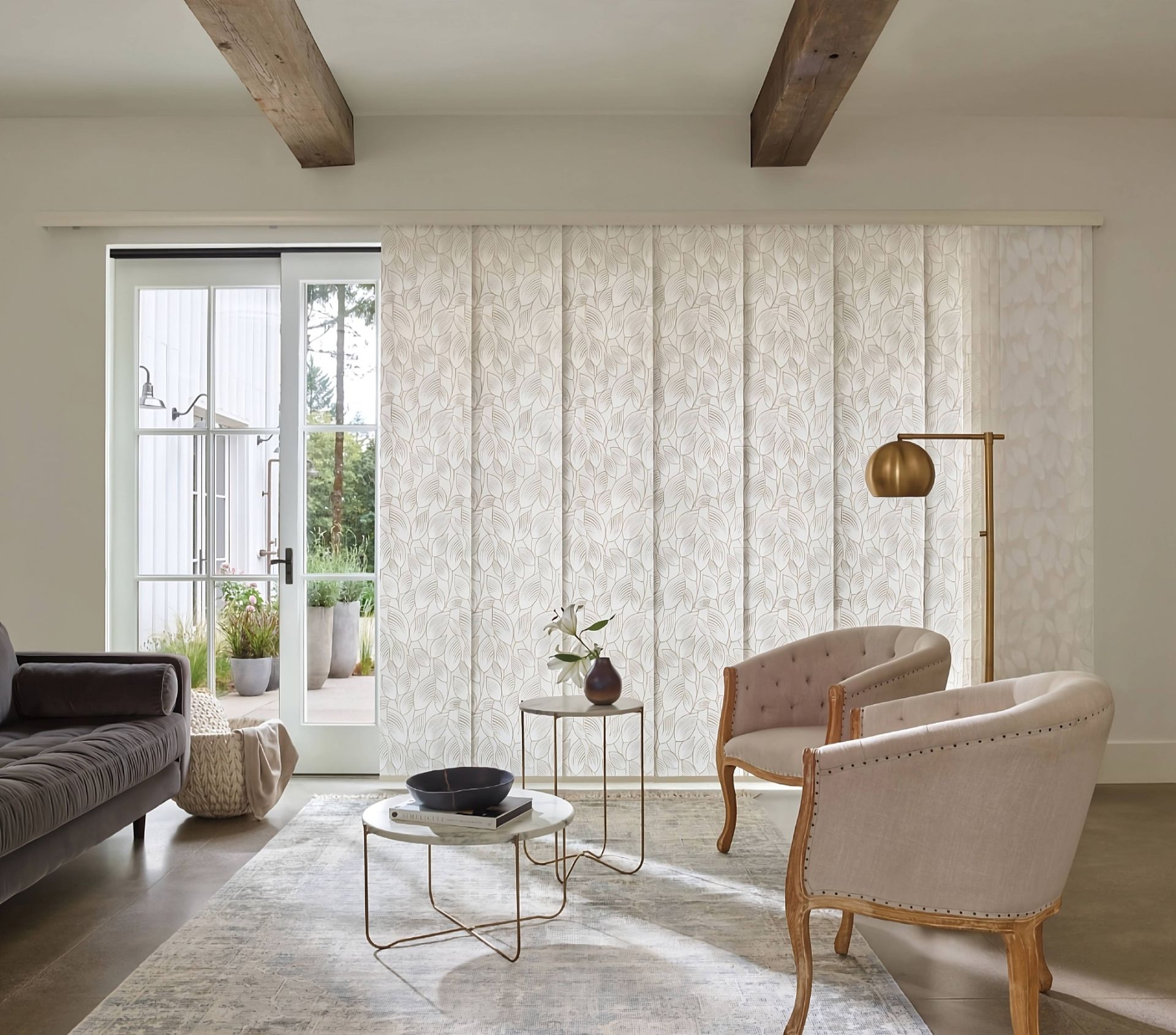 Neutral patterned Hunter Douglas Skyline® Panel-Track Blinds adorning a sliding patio door in a livi