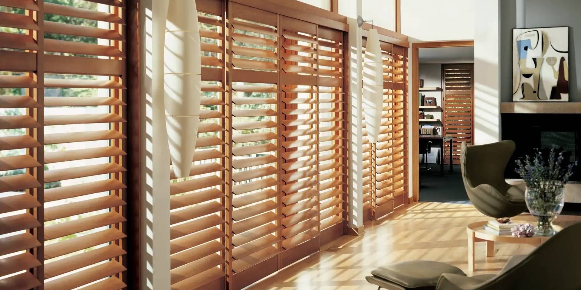 Alta Wood Shutters on an expansive set of windows in a lovely living room