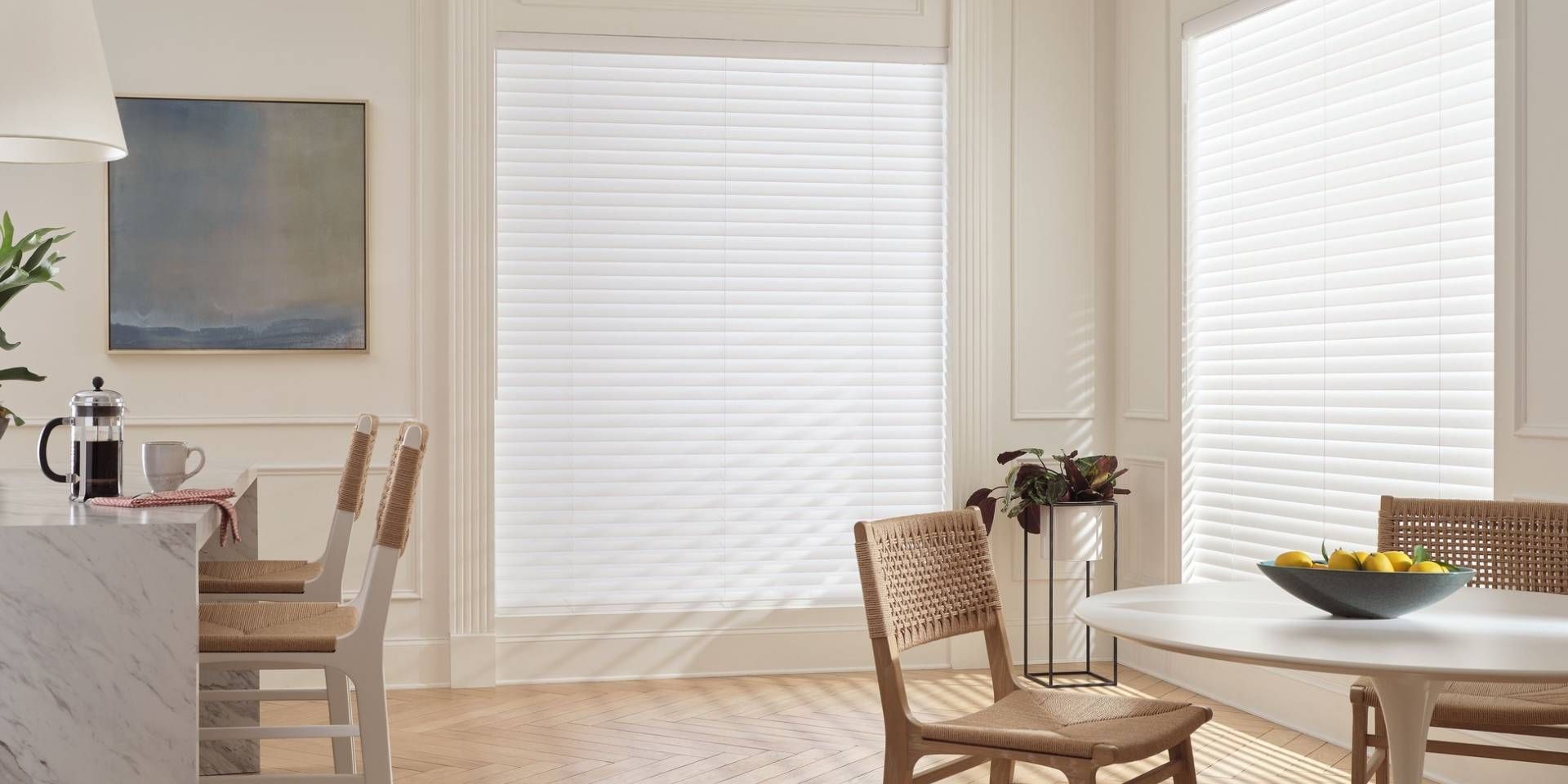 Elegant Hunter Douglas Aria™ Soft Blinds on two large windows in a stylish kitchen