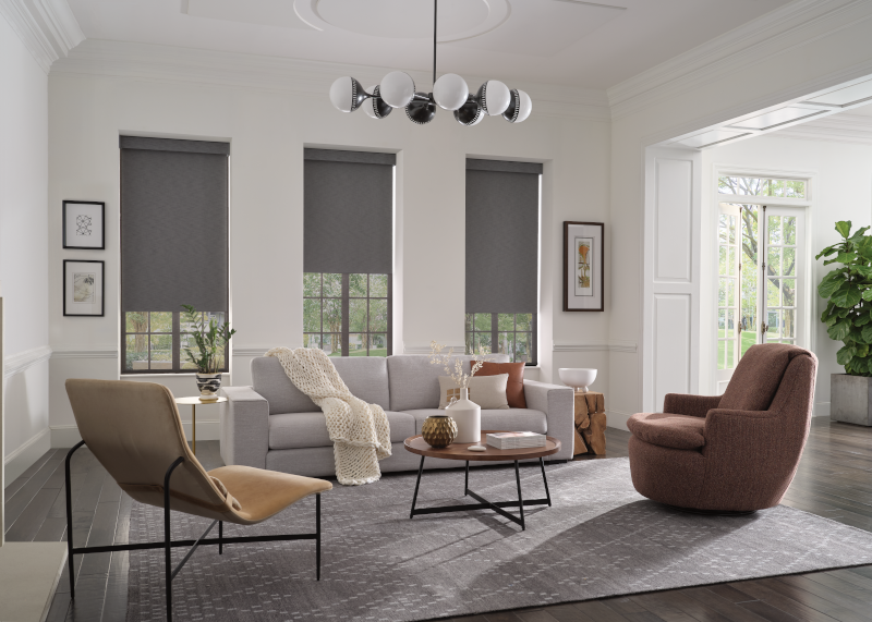 Hunter Douglas Designer Roller Shades on three tall windows in a contemporary living room 