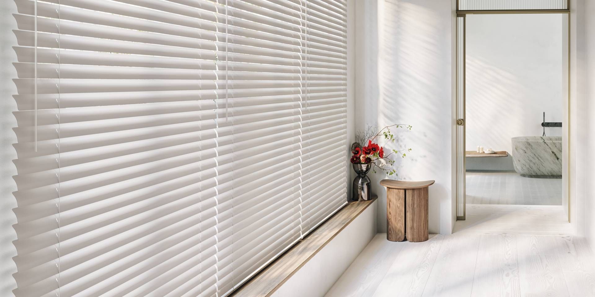Hunter Douglas Modern Precious Metals® Mini Blinds on a large window in a minimalist home