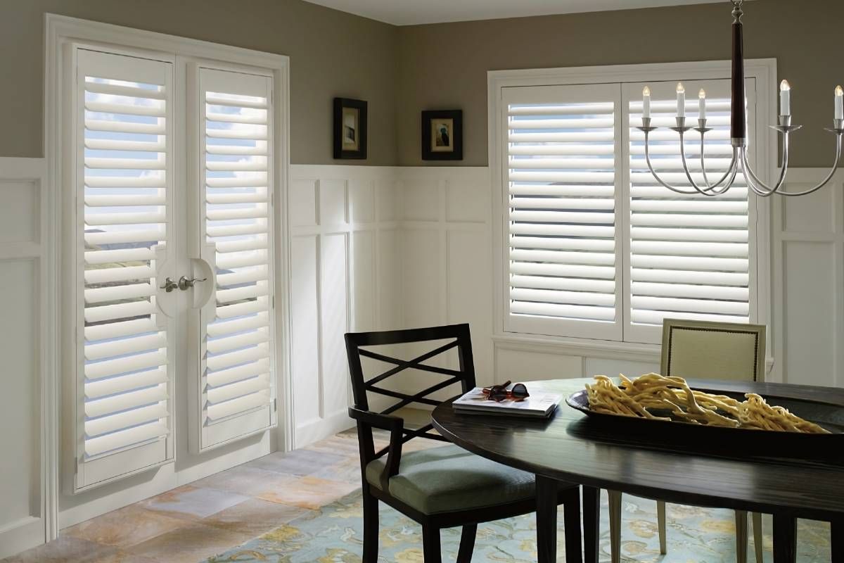 Hunter Douglas Palm Beach™ Polysatin™ Vinyl Shutters on windows and French doors in a dining room at Advantage Blinds near Prosper, Texas (TX)