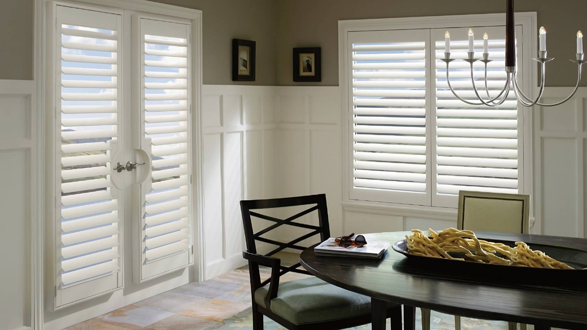 Hunter Douglas Palm Beach™ Polysatin™ Vinyl Shutters on windows and French doors in a dining room at