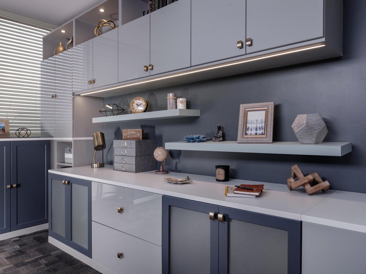 A home office system with a lot of cabinets and shelves.