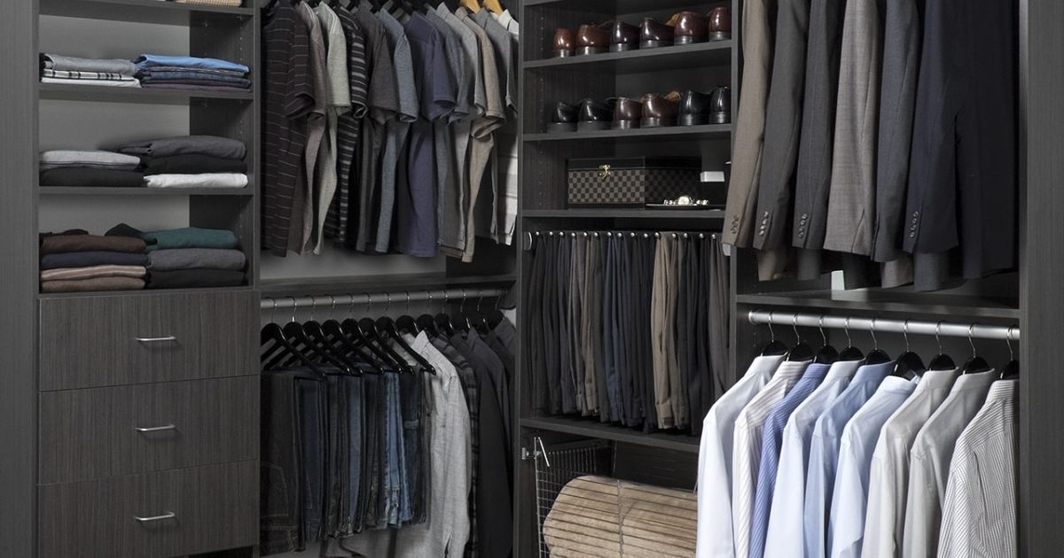 A walk in closet filled with lots of clothes and shoes.