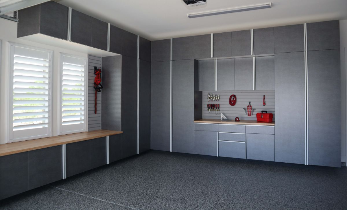 A garage with a lot of cabinets and a sink.