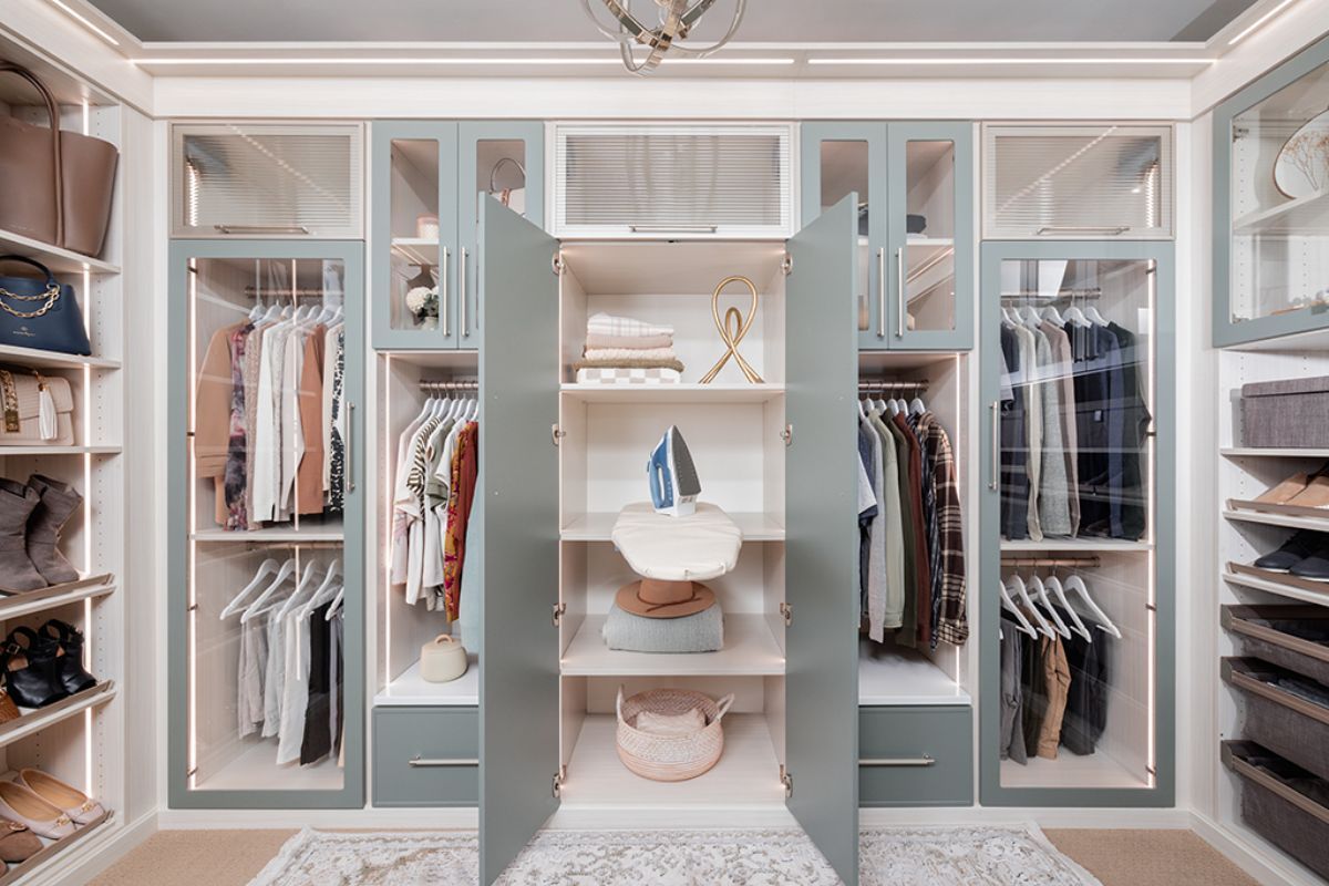 A walk in closet filled with lots of clothes and shoes.