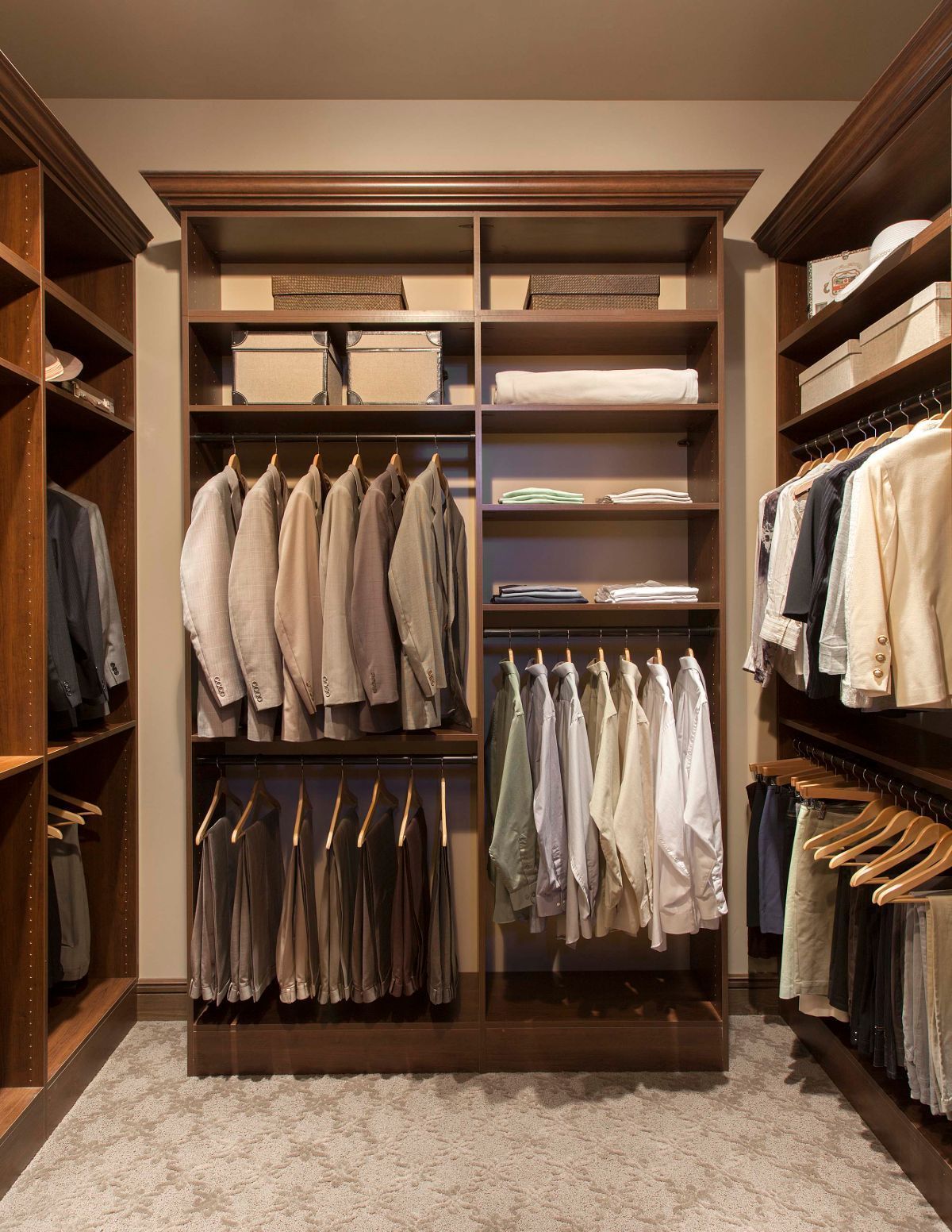 A walk in closet filled with lots of clothes and shelves.
