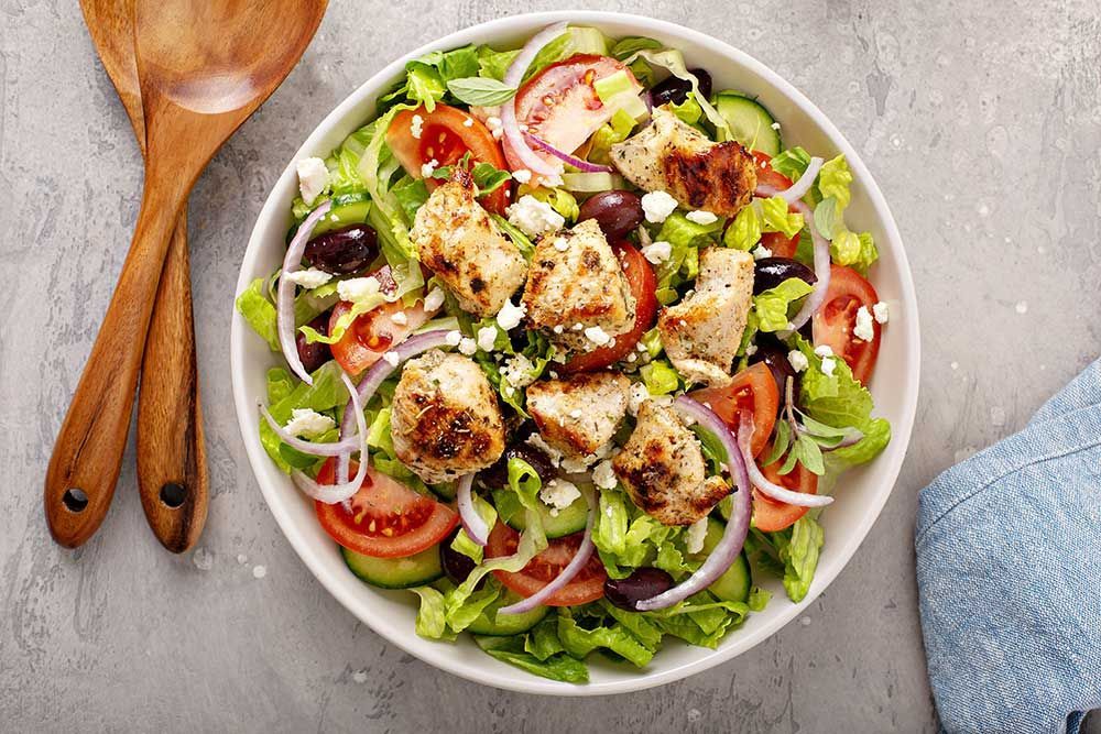 Greek salad with vinaigrette dressing topped