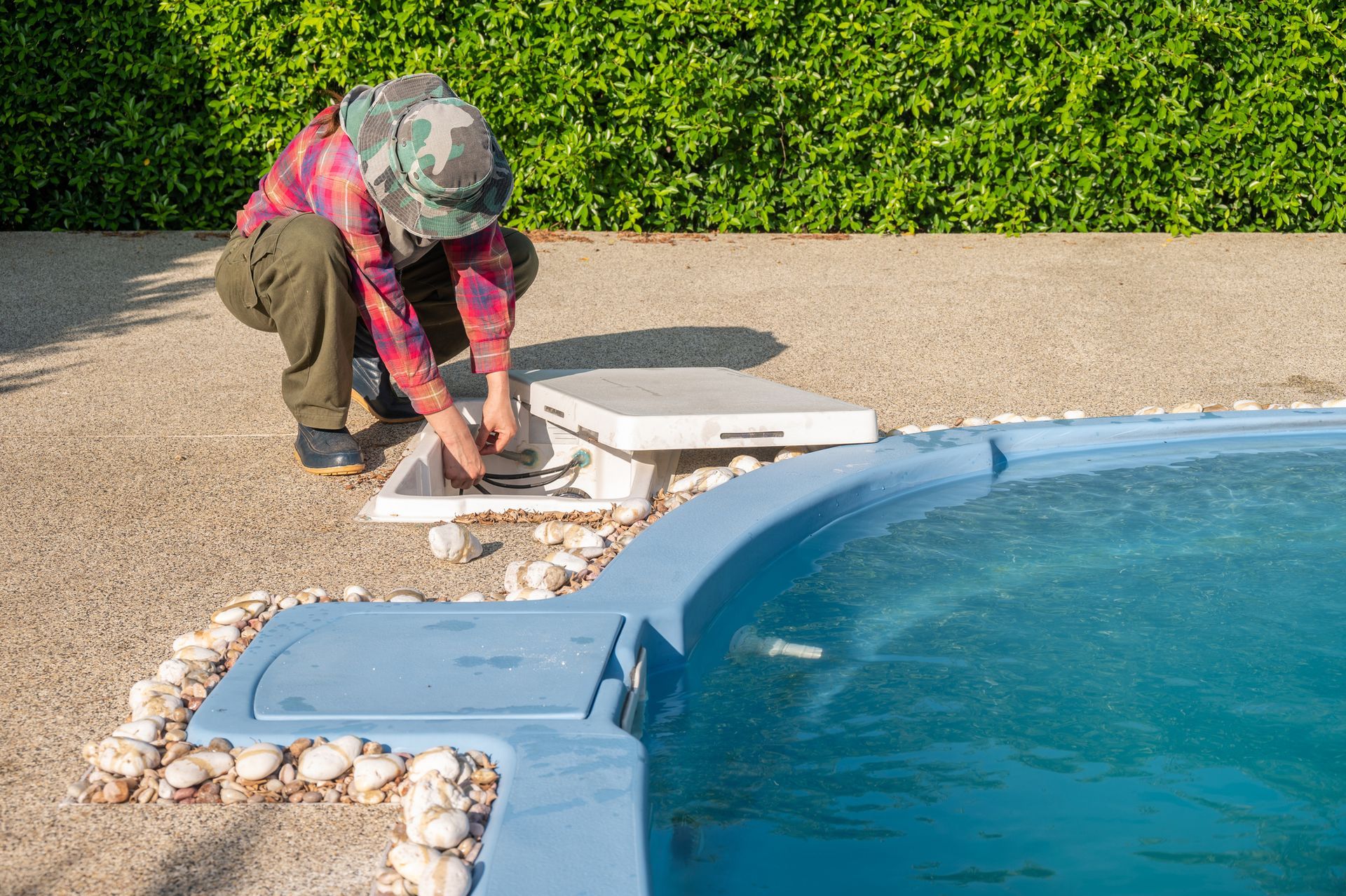 A man is working on a swimming pool.