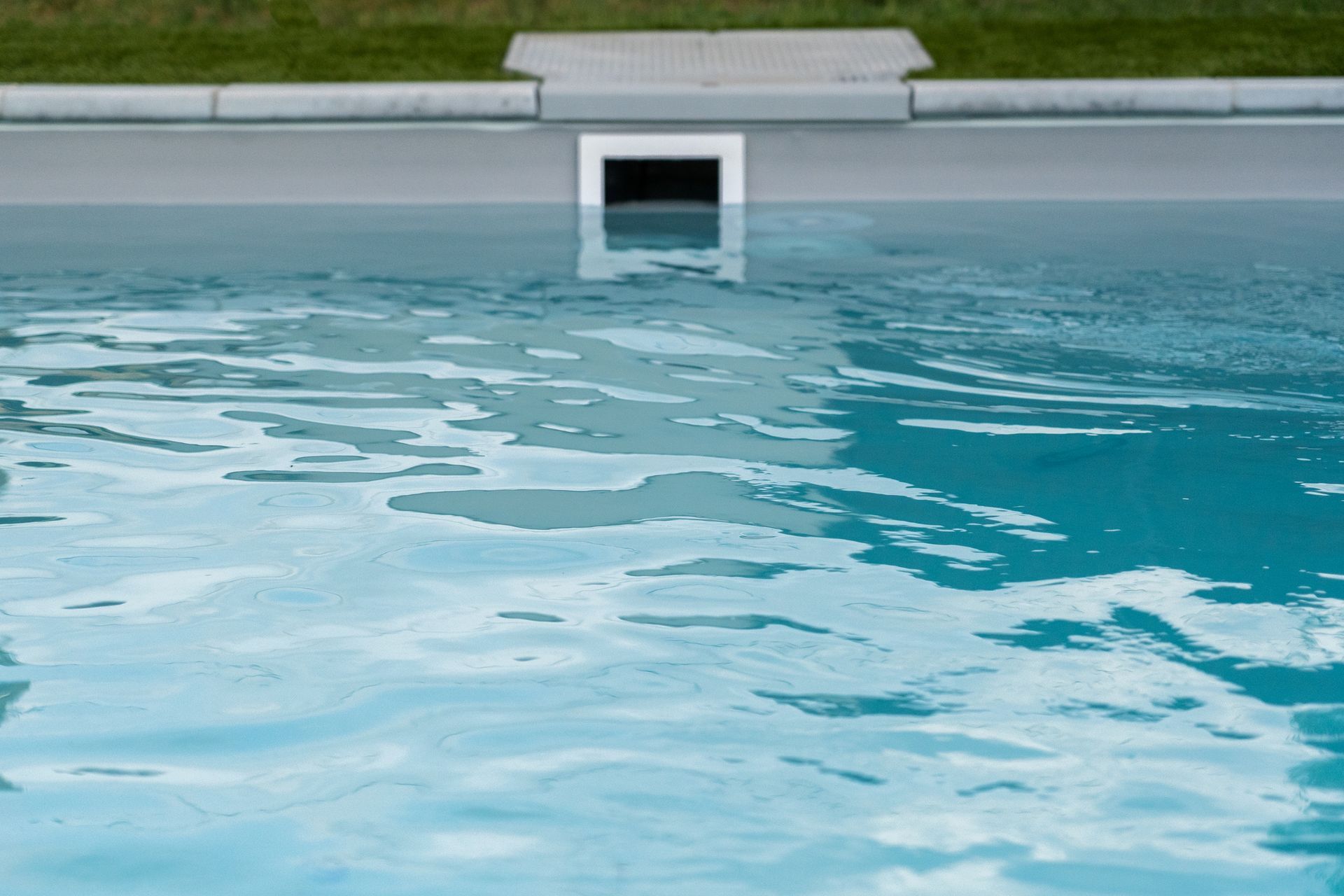 A swimming pool with a drain in the middle of it