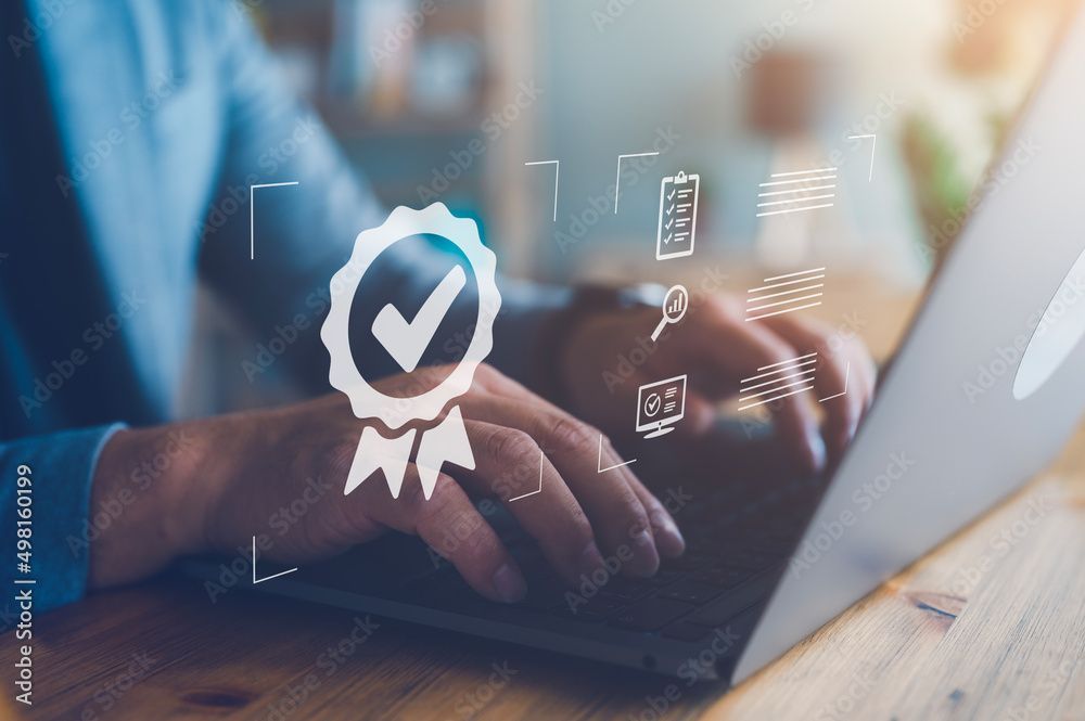 Hands typing on a laptop with a digital award and checkmark overlay