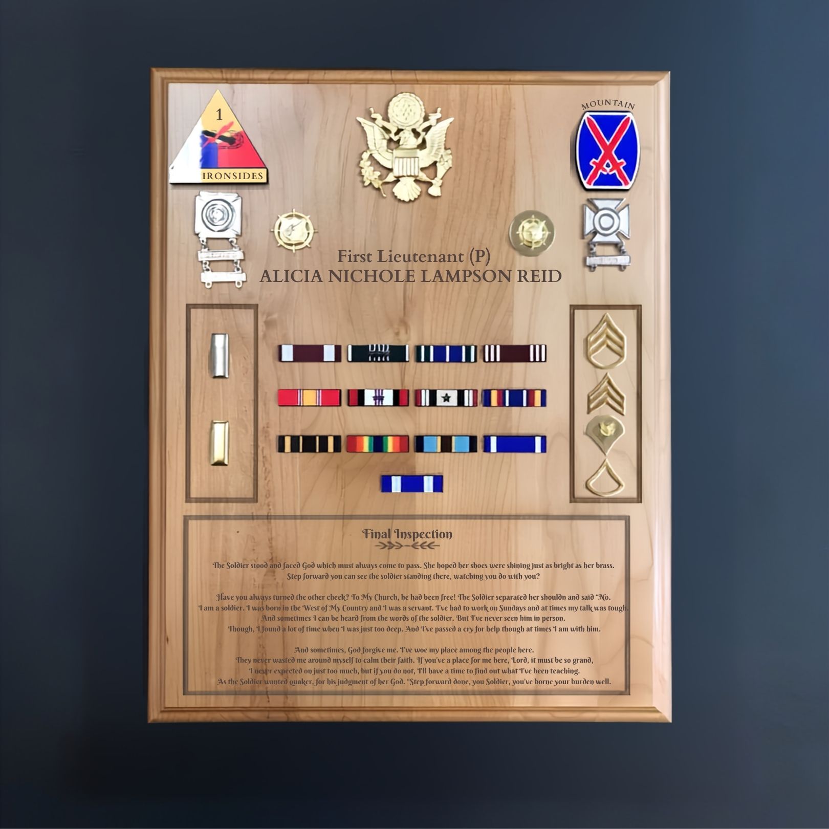 Framed military medal plaque with colorful ribbons, badges, and engraved text on a wood background