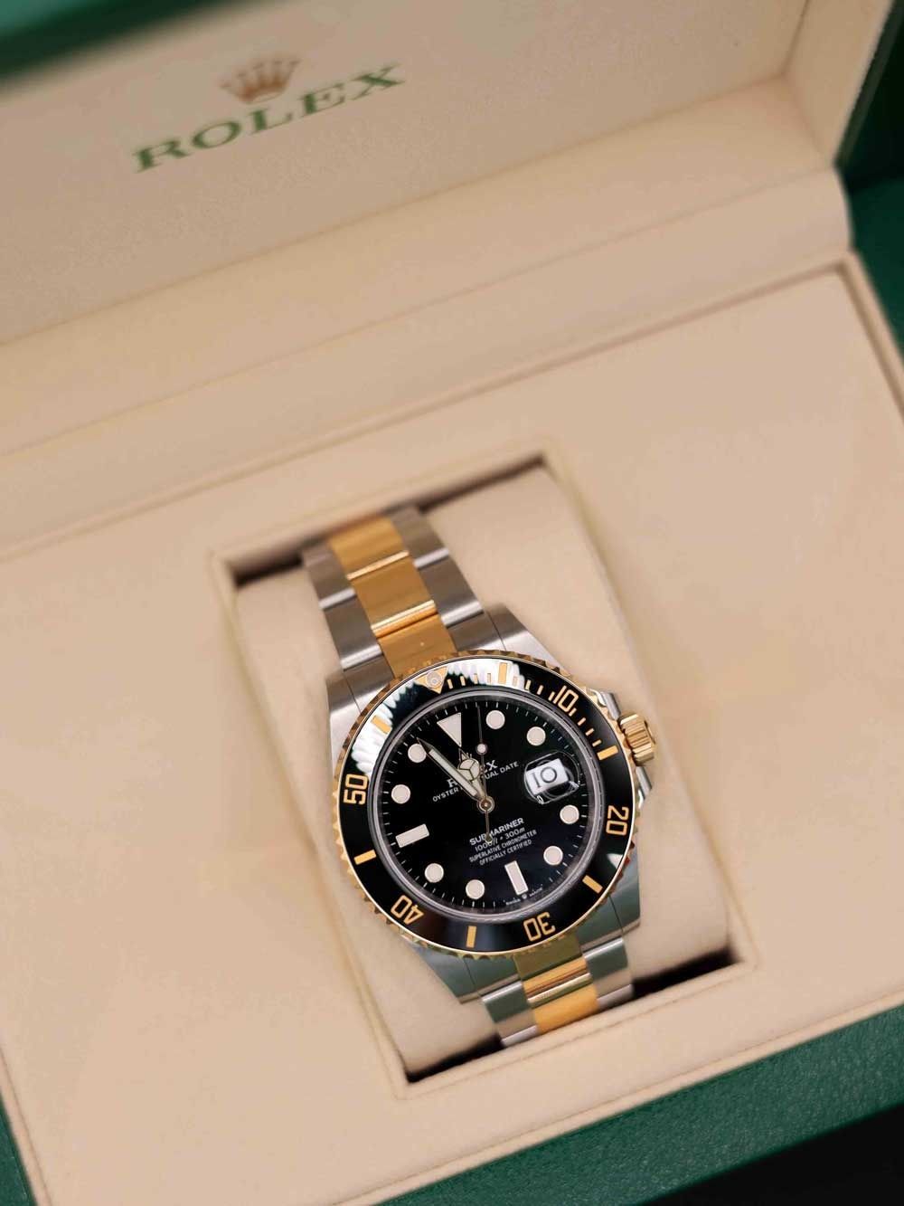 Rolex two-tone wristwatch with black dial in a presentation box