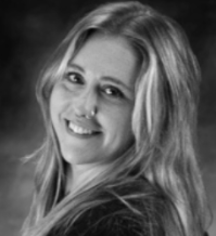 Smiling blonde woman in a black top, shown in a black-and-white portrait