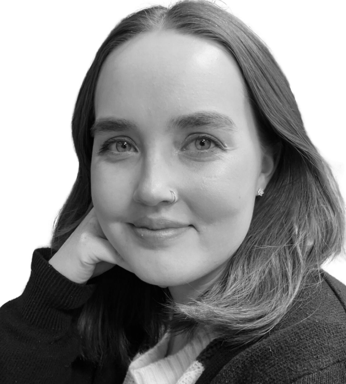 Black-and-white portrait of a smiling person resting their head on their hand.