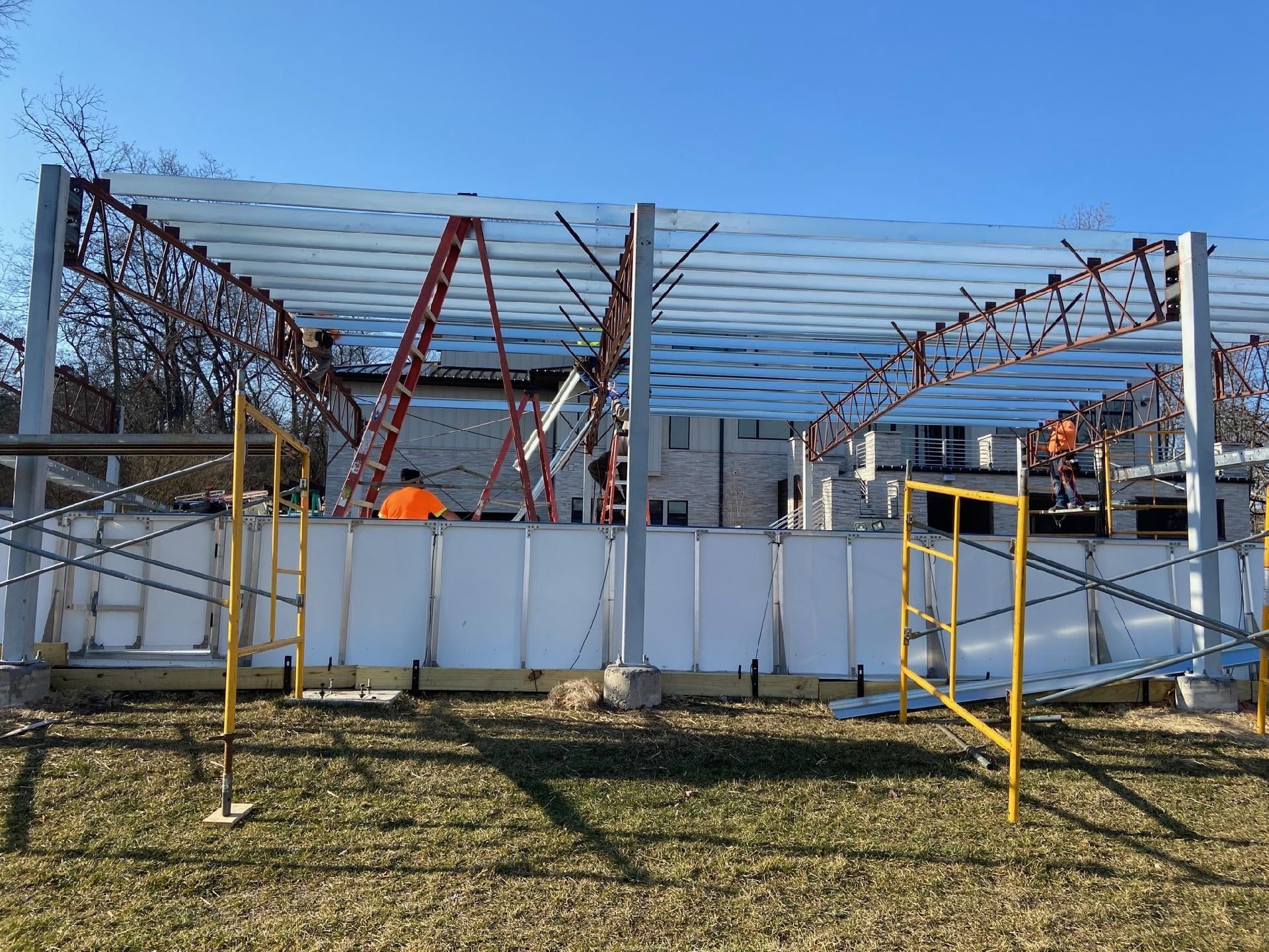 A building is being built in a field with scaffolding.