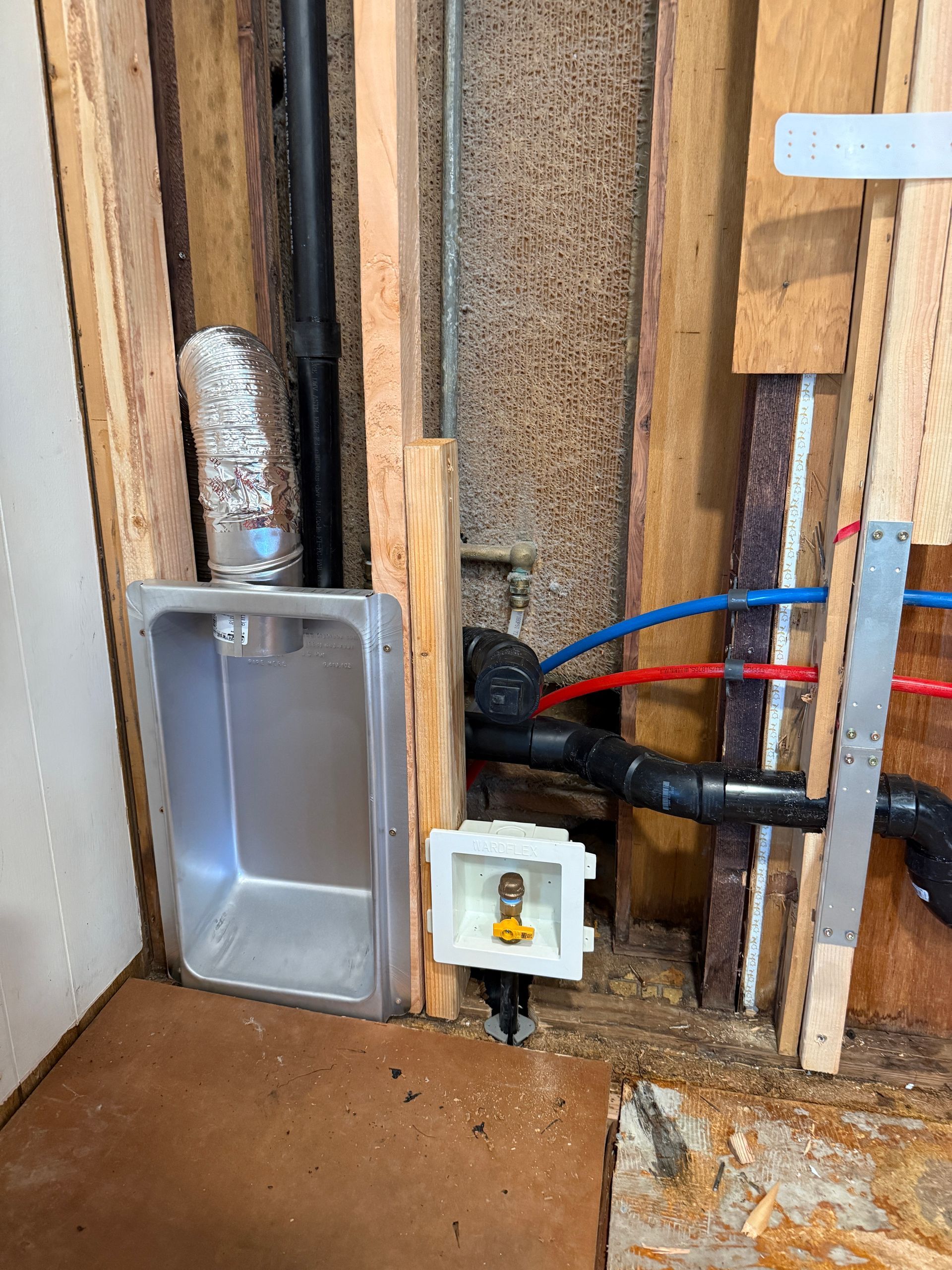 Rightway Plumbing Sewer And Drain - Laundry sink and water/drain connections exposed in a wall. PEX pipes, electrical outlet,