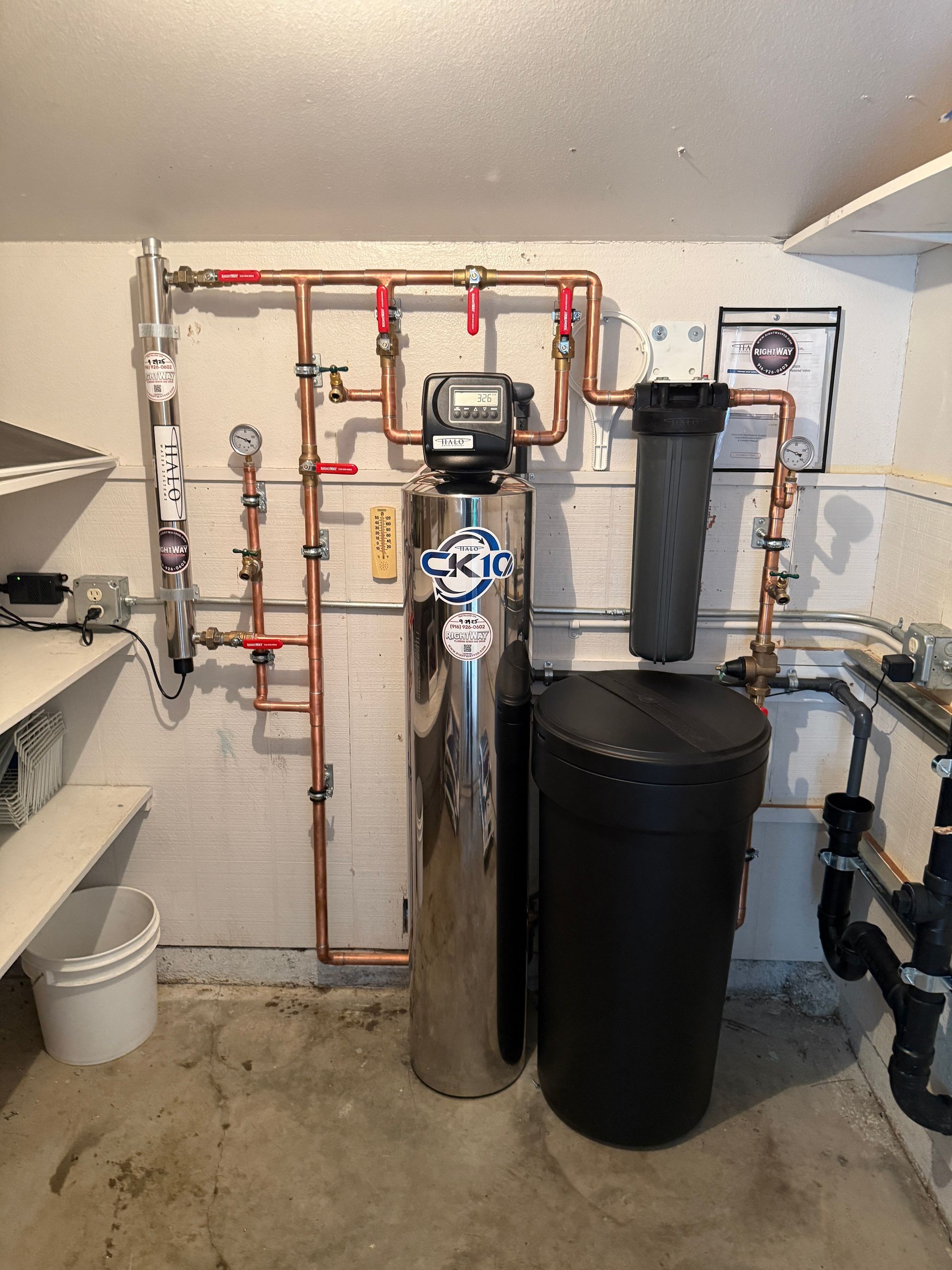 Rightway Plumbing Sewer And Drain - Water filtration system with copper pipes, stainless tank, and black filter/salt.