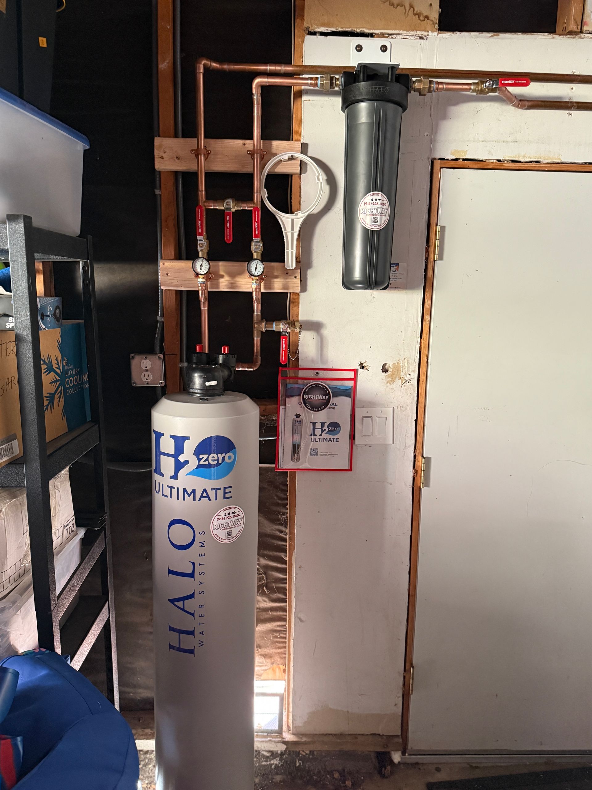 Basement utility area with a HALON fire suppression tank, exposed pipes, and a sprinkler control valve.