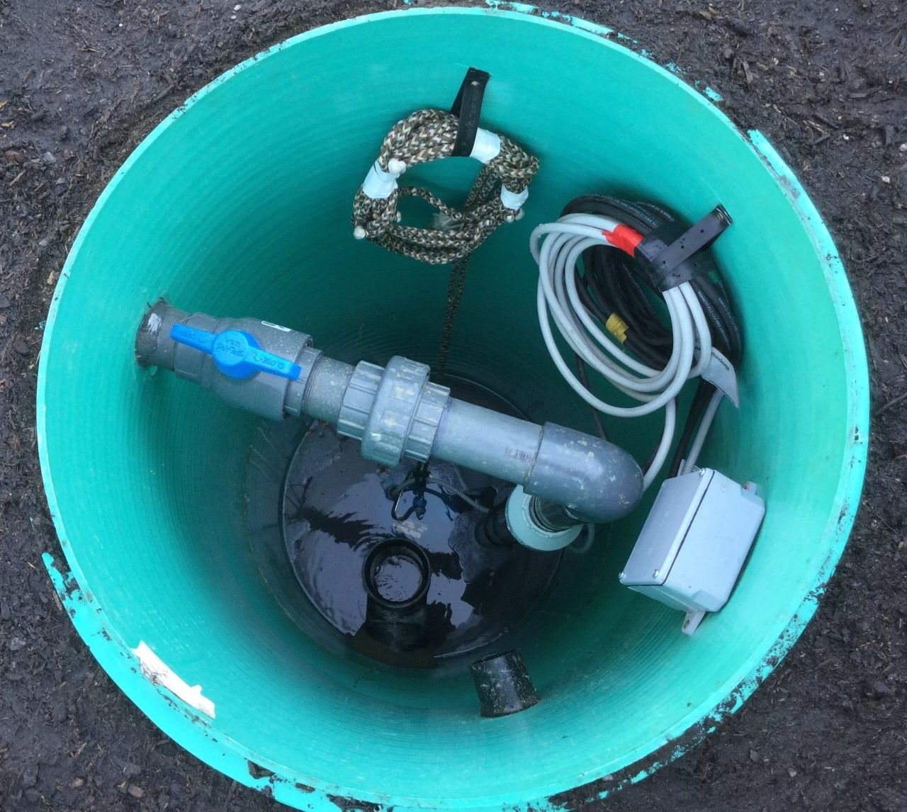 Rightway Plumbing Sewer And Drain - A green bucket with pipes and wires inside of it