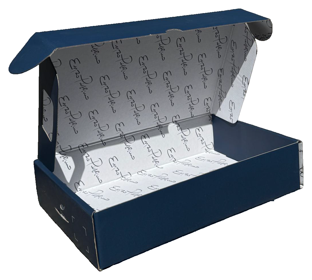 Scatola di cartone blu aperta con coperchio incernierato e interno stampato bianco, mostrata parzialmente aperta.
