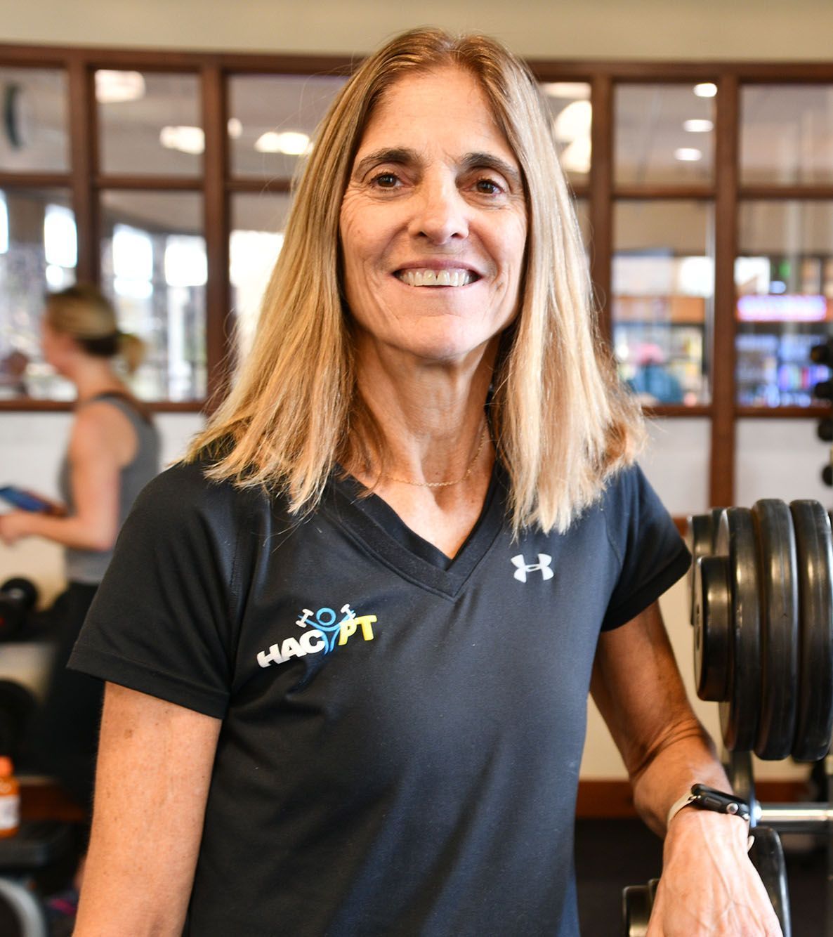 a woman wearing a black shirt that says hacpt