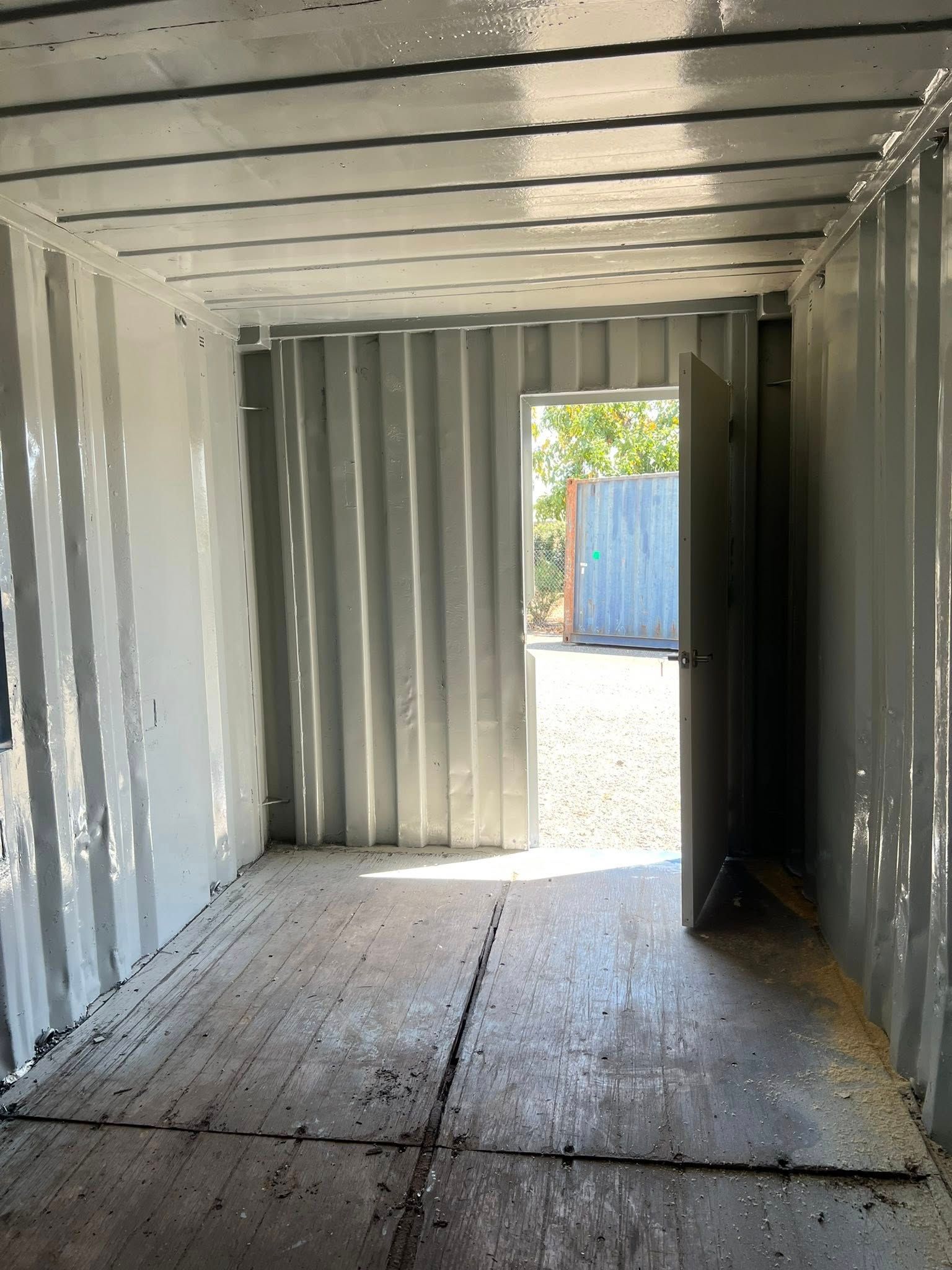 Interior of a Painted Shipping Container. Doorway Open to Outside  — Rockhampton Container Sales in Kawana, QLD