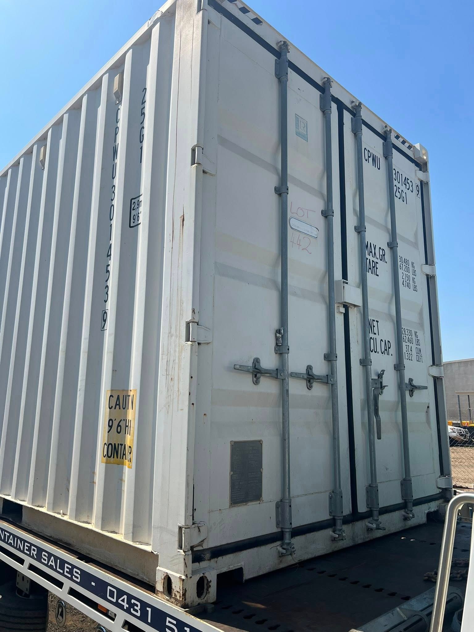 White Shipping Container on a Flatbed Trailer Against a Blue Sky  — Rockhampton Container Sales in Kawana, QLD