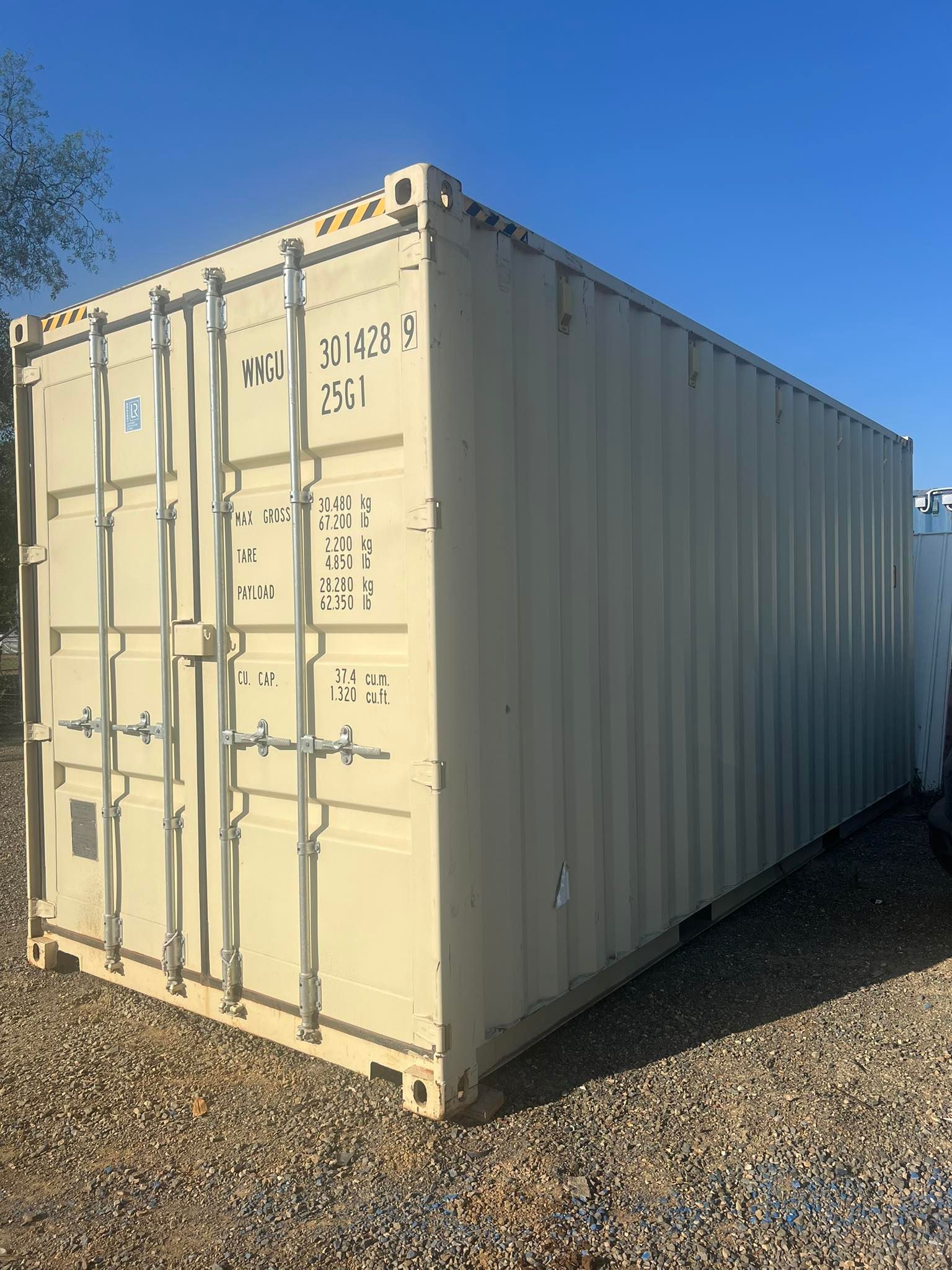 Tan Shipping Container on Gravel Against a Clear Blue Sky — Rockhampton Container Sales in Kawana, QLD