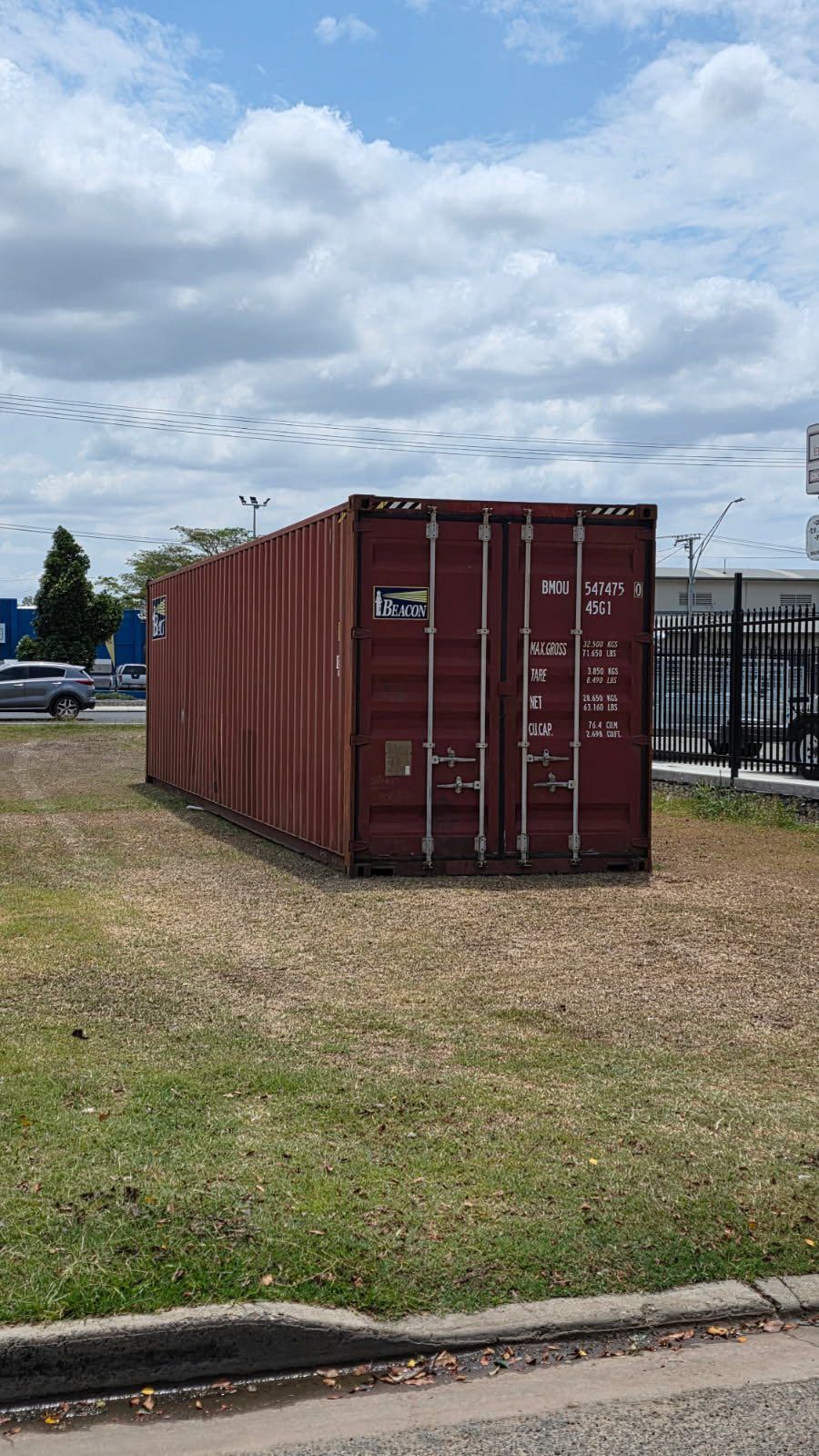 Red Shipping Container on a Grassy Area — Rockhampton Container Sales in Kawana, QLD