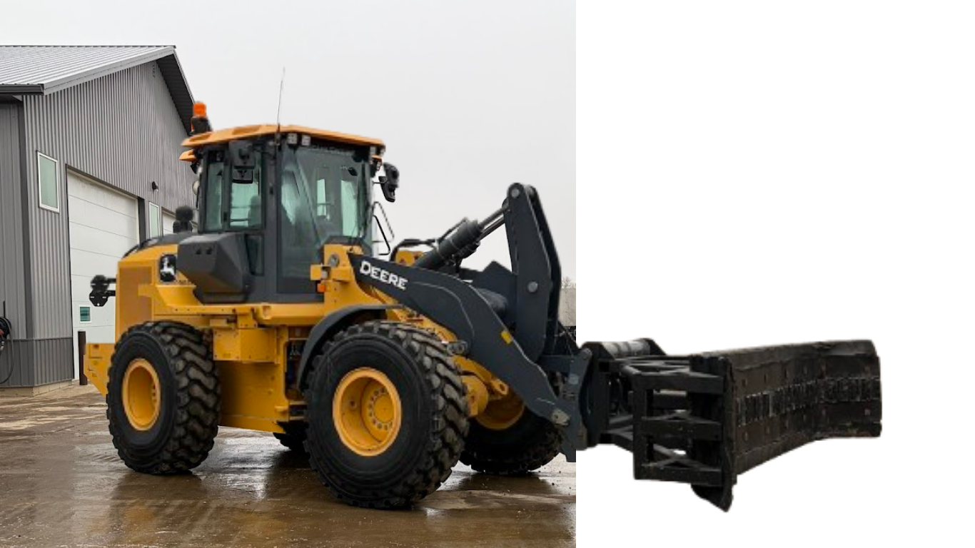 Yellow front loader with snowplow attachment parked beside a building on wet pavement