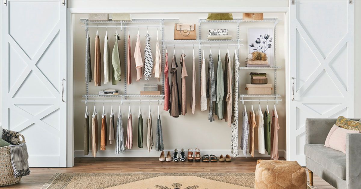 a walk in closet filled with lots of clothes and shoes .