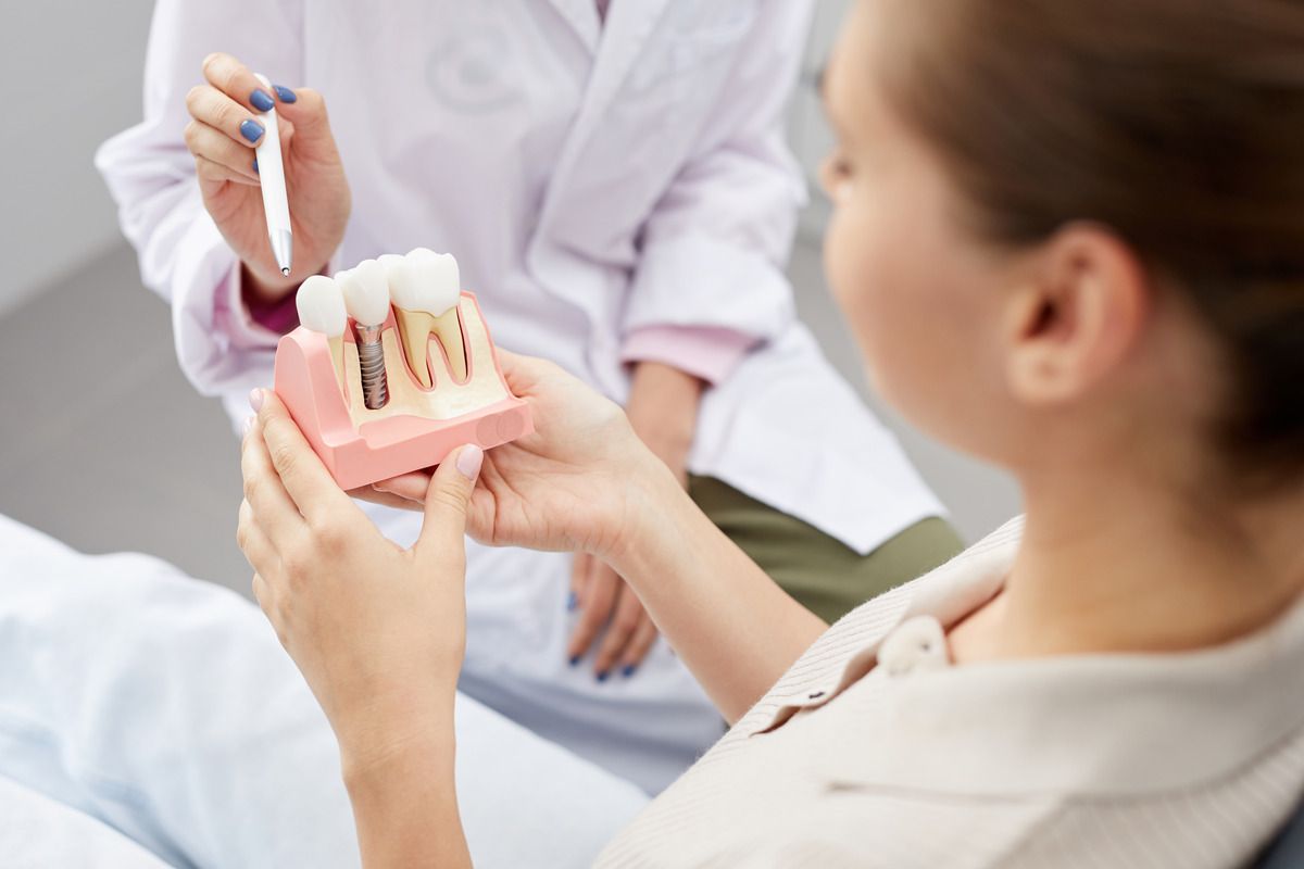 Get dental implants in Longmont CO Person holding dental implant mould | Dental implants family dentist Longmont CO