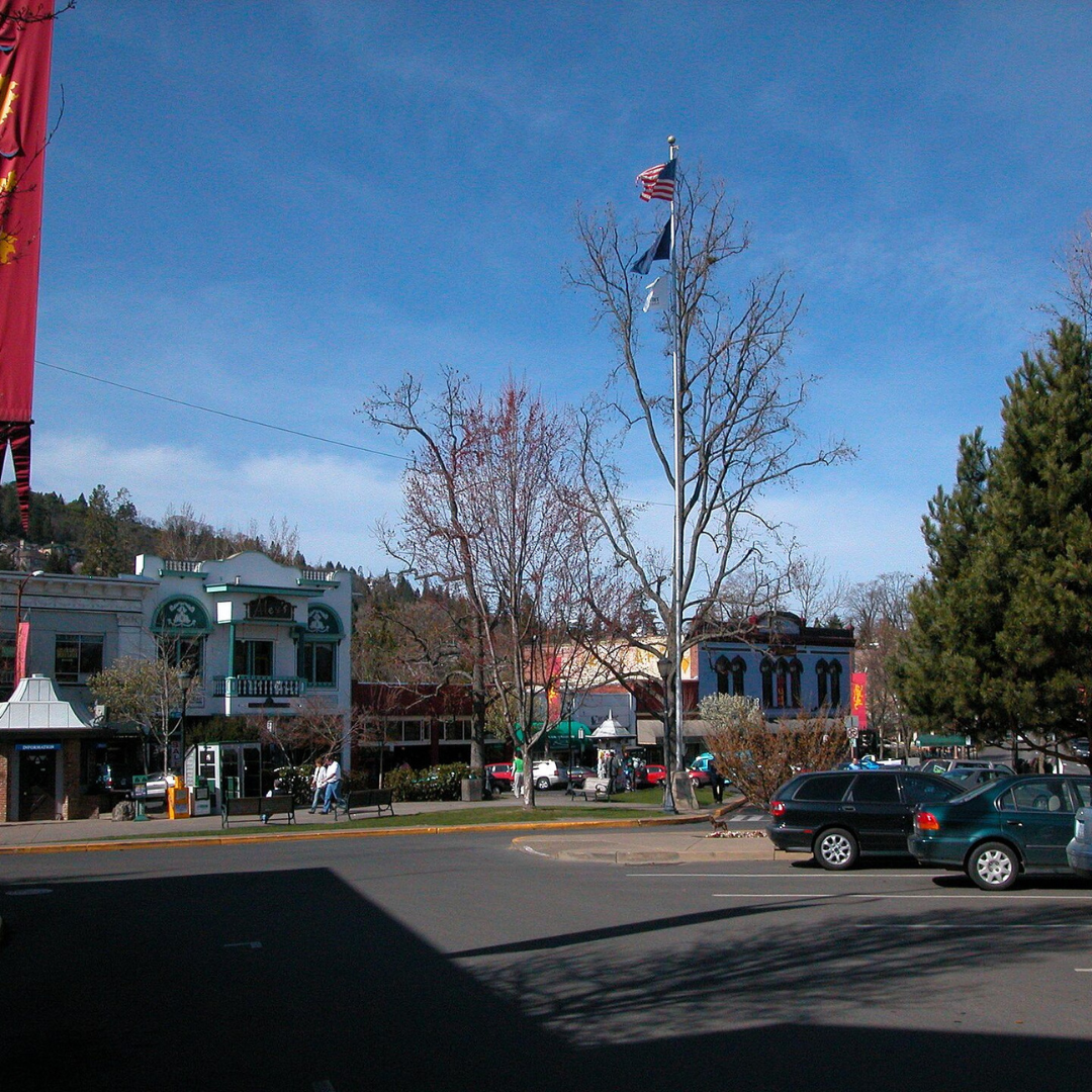 A street scene with a few cars parked on the side of the road